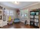 Bright bedroom with hardwood floors, white shuttered windows, and built in shelving at 212 Blossom Ln, Winter Park, FL 32789