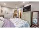 Spacious bedroom featuring updated paint, crown molding, and a view into the kitchen at 212 Blossom Ln, Winter Park, FL 32789