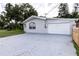 Home featuring a spacious driveway and an attached single car garage at 212 Blossom Ln, Winter Park, FL 32789