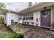 Charming front porch with slate flooring, an egg chair, and a welcoming American-themed door decoration at 212 Blossom Ln, Winter Park, FL 32789
