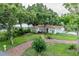 Charming single-story home with a brick pathway and beautiful lawn at 212 Blossom Ln, Winter Park, FL 32789