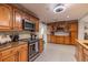 Spacious kitchen with updated cabinetry, granite counters, and modern stainless steel appliances at 212 Blossom Ln, Winter Park, FL 32789