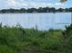 Beautiful lake view from the property showcasing clear water, distant buildings, and scenic horizon at 212 Blossom Ln, Winter Park, FL 32789