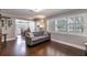 Cozy living room with dark hardwood floors, neutral decor and direct access to the dining room at 212 Blossom Ln, Winter Park, FL 32789