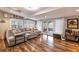 Comfortable living room features natural light, stylish wood flooring, and access to the patio at 212 Blossom Ln, Winter Park, FL 32789