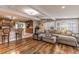 Inviting open-plan living room and kitchen with hardwood floors, comfortable seating, and pendant lighting at 212 Blossom Ln, Winter Park, FL 32789
