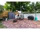 Private brick patio features outdoor seating, grill, fire pit, and storage at 212 Blossom Ln, Winter Park, FL 32789