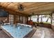 Indoor patio featuring a wood ceiling, hanging fans, a long table, and multiple seating options at 212 Blossom Ln, Winter Park, FL 32789