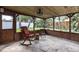 Cozy screened porch with stone flooring, wood paneling and a beautiful view of the garden at 212 Blossom Ln, Winter Park, FL 32789