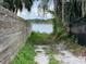 Property includes private access to the water, surrounded by lush greenery and a wooden fence at 212 Blossom Ln, Winter Park, FL 32789