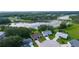 Scenic aerial view of homes in a cul-de-sac, backing onto a pond with lush green surroundings at 24954 Navel Ave, Leesburg, FL 34748