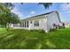 Charming backyard with lush green lawn, mature landscaping, and screened patio at 24954 Navel Ave, Leesburg, FL 34748