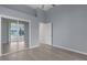 Bedroom with a mirrored closet, hardwood floors, and a view of the screened-in porch at 24954 Navel Ave, Leesburg, FL 34748