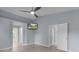 Bedroom with a vaulted ceiling, hardwood floors, and a modern ceiling fan at 24954 Navel Ave, Leesburg, FL 34748