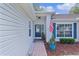 Inviting front entry with brick walkway, blue door, and well-maintained landscaping at 24954 Navel Ave, Leesburg, FL 34748