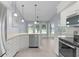 Bright kitchen with white cabinets, stainless steel appliances, and pendant lighting above the sink at 24954 Navel Ave, Leesburg, FL 34748
