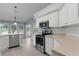 Well-lit kitchen with stainless steel appliances, white cabinetry, and views of the backyard at 24954 Navel Ave, Leesburg, FL 34748