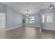 Bright living room featuring modern lighting, fresh paint, and wood-look flooring at 24954 Navel Ave, Leesburg, FL 34748