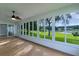 Screened-in porch with views of the lush backyard and lake at 24954 Navel Ave, Leesburg, FL 34748