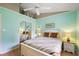 Bedroom featuring light blue walls, ceiling fan, and mirrored closet at 26034 Oakmount Dr, Leesburg, FL 34748