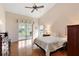 Bedroom features a ceiling fan, and sliding glass doors leading to lanai at 26034 Oakmount Dr, Leesburg, FL 34748