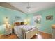 Bedroom with soft blue paint, a white ceiling fan, and a bed at 26034 Oakmount Dr, Leesburg, FL 34748