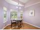 Breakfast nook with a table and chairs, large windows, and views of the backyard at 26034 Oakmount Dr, Leesburg, FL 34748