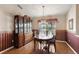 Dining room features hardwood floors, a chandelier, and a wooden china cabinet at 26034 Oakmount Dr, Leesburg, FL 34748