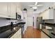 Modern kitchen featuring stainless steel appliances, granite countertops, and ample cabinet space at 26034 Oakmount Dr, Leesburg, FL 34748