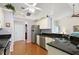 Bright kitchen with white cabinets, stainless steel appliances, and hardwood flooring at 26034 Oakmount Dr, Leesburg, FL 34748