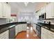 Bright kitchen featuring white cabinets, stainless steel appliances, and granite countertops at 26034 Oakmount Dr, Leesburg, FL 34748