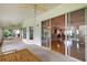 Enclosed lanai with a ceiling fan and glass sliding doors looking into the house and back yard at 26034 Oakmount Dr, Leesburg, FL 34748