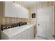 Functional laundry room with washer, dryer, and ample storage cabinets for convenience and organization at 26034 Oakmount Dr, Leesburg, FL 34748