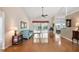 Bright living room with hardwood flooring, a ceiling fan, and sliding glass doors to the patio at 26034 Oakmount Dr, Leesburg, FL 34748