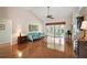 Spacious living room with hardwood floors, ceiling fan, and access to the outdoor patio at 26034 Oakmount Dr, Leesburg, FL 34748
