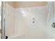 Shower stall with built-in seat, grab bars, and white tile at 26034 Oakmount Dr, Leesburg, FL 34748