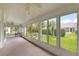 Enclosed sunroom with lots of light and views to the lush and well-manicured back yard at 26034 Oakmount Dr, Leesburg, FL 34748