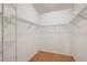 Walk-in closet has wood flooring and wire shelving throughout at 26034 Oakmount Dr, Leesburg, FL 34748