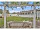 Inviting backyard featuring a swing, lush lawn, white fence, and a screened-in patio, perfect for relaxation and outdoor enjoyment at 2743 Nattie Ct, Orlando, FL 32826