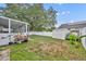 Spacious backyard with a screen lanai and utility shed at 2743 Nattie Ct, Orlando, FL 32826