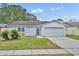 Charming one-story home with a well-maintained lawn and an attached garage at 2743 Nattie Ct, Orlando, FL 32826
