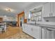 Bright kitchen with white cabinets, granite countertops, stainless steel appliances, and wood floors at 2743 Nattie Ct, Orlando, FL 32826
