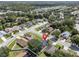 Aerial view of a charming residential neighborhood with tree-lined streets and well-kept homes at 2849 Doe Run Trl, Orange City, FL 32763