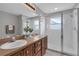 Bathroom with a double sink vanity, glass enclosed shower, and neutral finishes at 2849 Doe Run Trl, Orange City, FL 32763