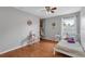 Bright bedroom features a closet, window, bed, hardwood floors, and vanity at 2849 Doe Run Trl, Orange City, FL 32763
