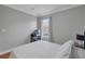 Bedroom features a large window, hardwood floors, and a bed with a patterned comforter at 2849 Doe Run Trl, Orange City, FL 32763