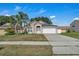 Charming single-story home with a well-manicured lawn and two-car garage on a sunny day at 2849 Doe Run Trl, Orange City, FL 32763