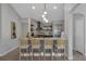 Well-lit kitchen island with stylish bar stools, a modern sink, and an open layout, perfect for entertaining at 2849 Doe Run Trl, Orange City, FL 32763
