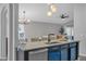 Bright kitchen with seating at the island, stainless appliances, and an open floorplan at 2849 Doe Run Trl, Orange City, FL 32763