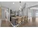The kitchen island features a unique tiled base, seating, and modern lighting at 2849 Doe Run Trl, Orange City, FL 32763